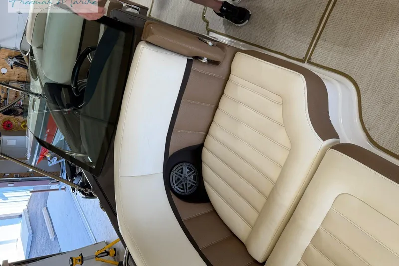 Slide: The Image of Interior of a 2016 Marker One M25 boat with beige and brown seating. - 16