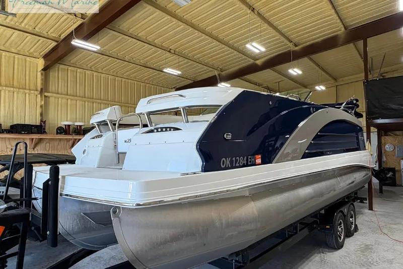 Slide: The Image of 2016 Marker One M25 pontoon boat in a storage facility. - 2