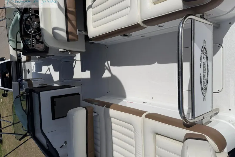Slide: The Image of 2016 Marker One M25 boat interior with white and brown seating. - 20