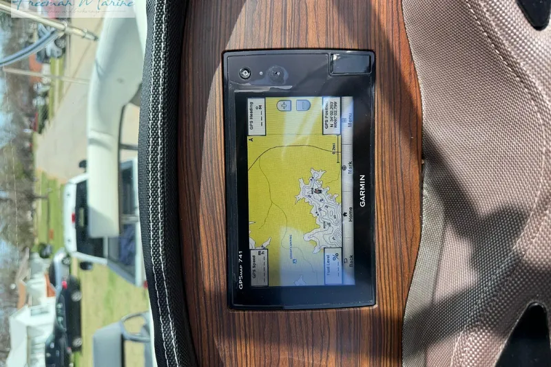 Slide: The Image of Garmin GPS navigation system on a 2016 Marker One M25 boat dashboard. - 22