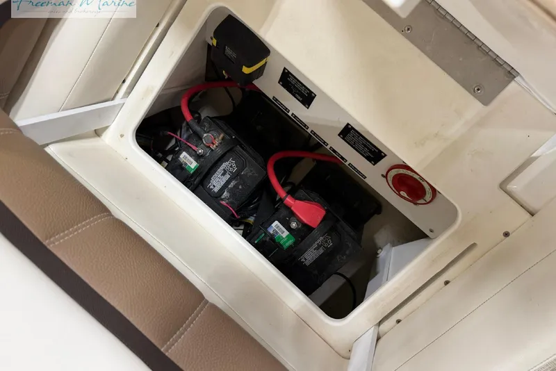 Slide: The Image of Battery compartment of a 2016 Marker One M25 boat, featuring dual batteries and wiring. - 26
