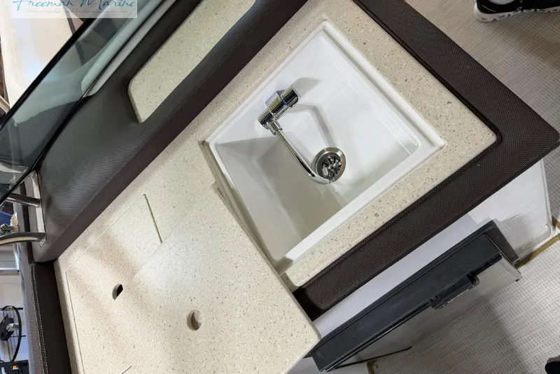 Slide: The Image of 2016 Marker One M25 boat sink with beige countertop and modern faucet. - 27