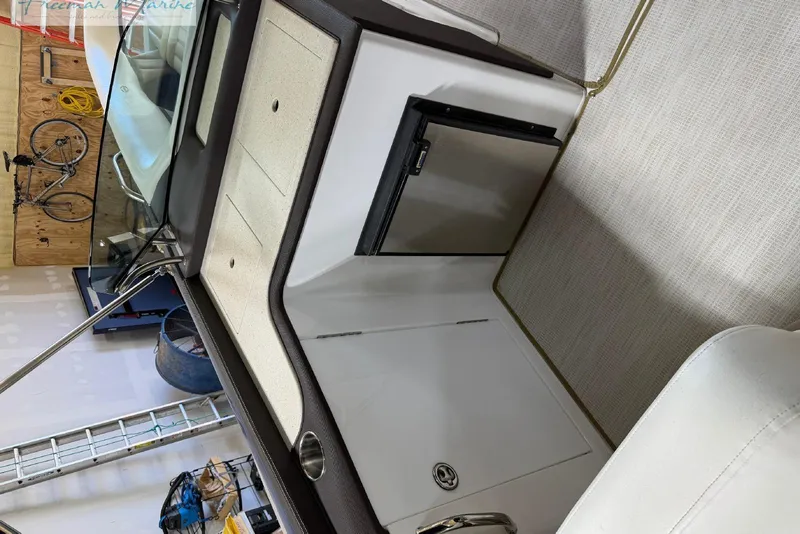 Slide: The Image of Interior of a 2016 Marker One M25 boat with seating and storage. - 3