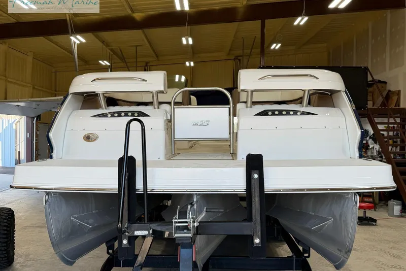 Slide: The Image of 2016 Marker One M25 pontoon boat in a warehouse setting. - 4
