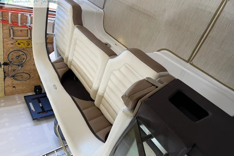 Slide: The Image of Interior of a 2016 Marker One M25 boat with beige and white seating. - 5