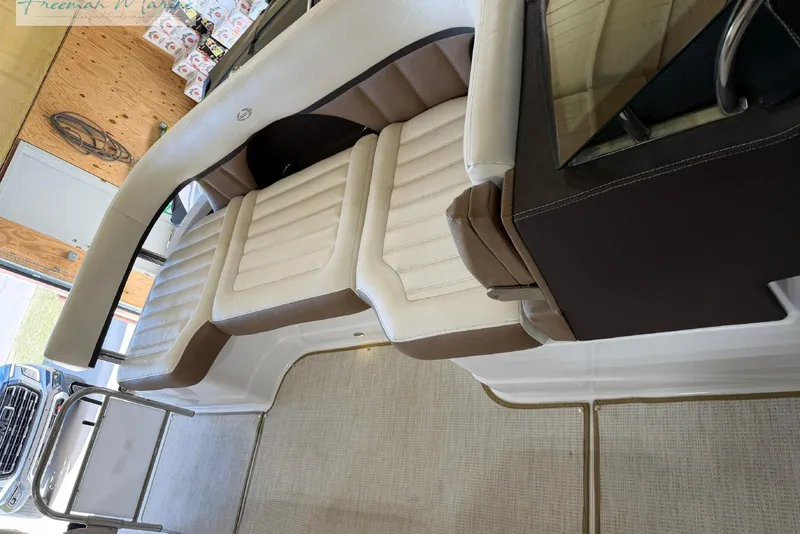 Slide: The Image of Interior of a 2016 Marker One M25 boat with beige and brown seating. - 6