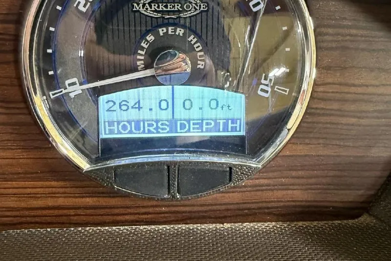 Slide: The Image of Marker One M25 tachometer displaying 264 hours, 0 feet depth. - 8