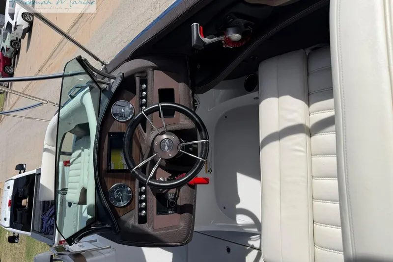 Slide: The Image of Cockpit view of a 2016 Marker One M25 boat with steering wheel and controls. - 9