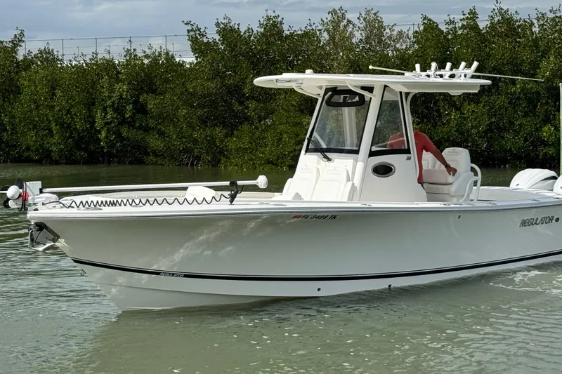 Slide: The Image of 2022 Regulator 28 boat on calm water near mangroves. - 10