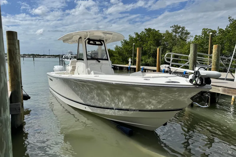 Slide: The Image of 2022 Regulator 28 boat docked in a serene marina setting. - 16