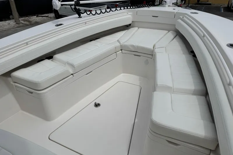 Slide: The Image of 2022 Regulator 28 boat interior with white cushioned seating and spacious deck area. - 33