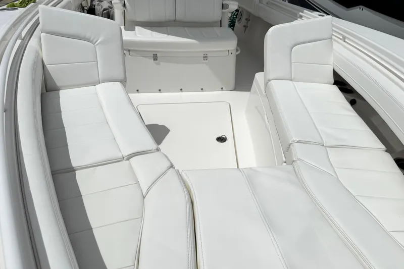 Slide: The Image of 2022 Regulator 28 boat interior with white cushioned seating and storage area. - 35