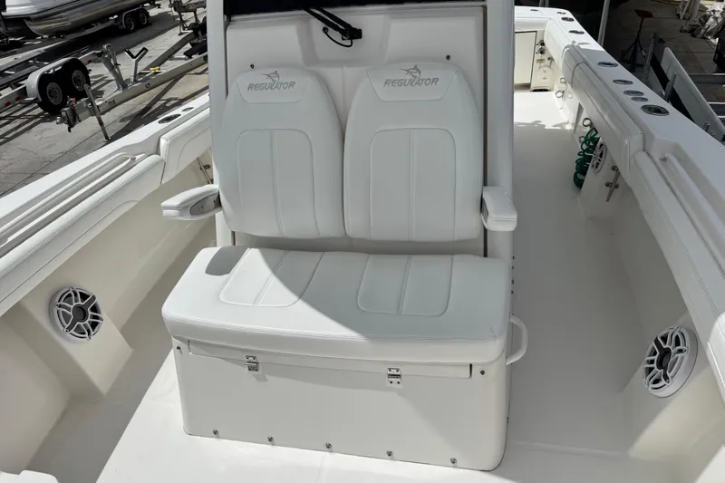 Slide: The Image of 2022 Regulator 28 boat interior with white seating and speakers. - 36
