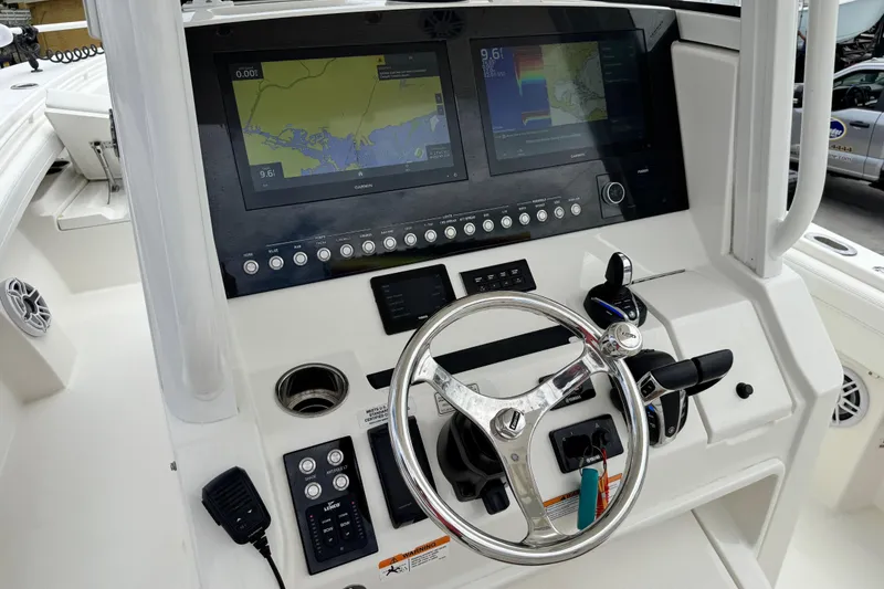 Slide: The Image of 2022 Regulator 28 boat dashboard with steering wheel and navigation screens. - 46