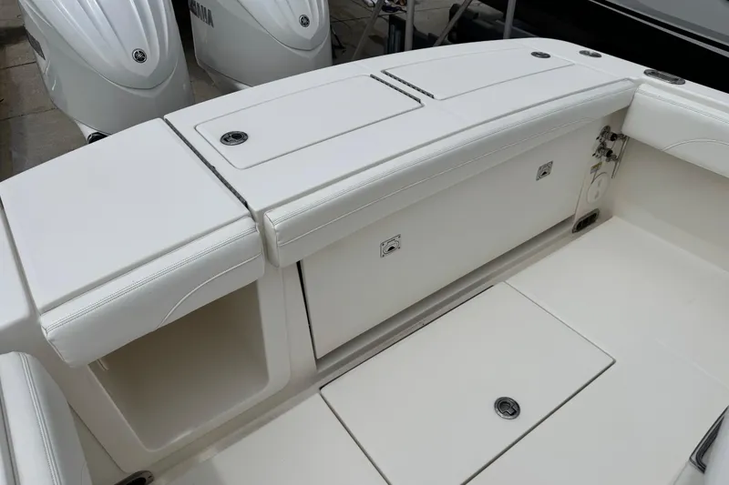 Slide: The Image of 2022 Regulator 28 boat interior with white seating and storage compartments. - 51