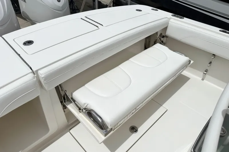 Slide: The Image of 2022 Regulator 28 boat with white foldable seating and storage compartment. - 52