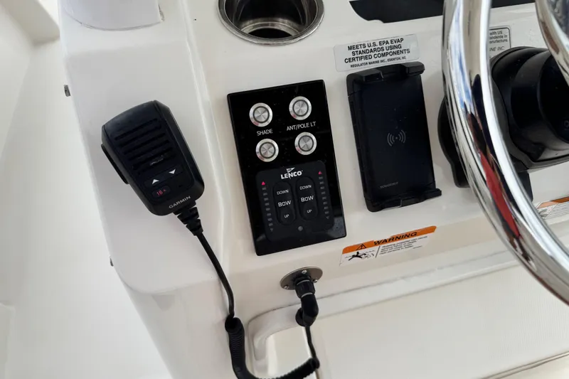 Slide: The Image of Control panel of a 2022 Regulator 28 boat with Garmin radio and steering wheel. - 56