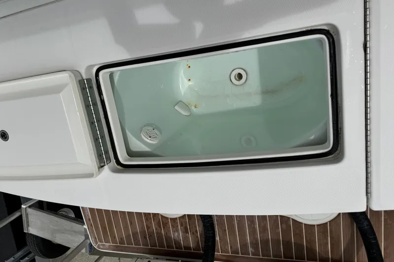 Slide: The Image of Open storage compartment on 2022 Regulator 28 boat, showing interior details. - 59