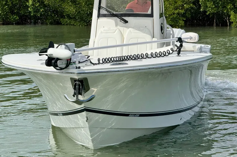 Slide: The Image of 2022 Regulator 28 boat cruising on calm water, featuring sleek design and advanced equipment. - 6