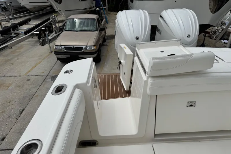 Slide: The Image of 2022 Regulator 28 boat with Yamaha engines, parked near a beige truck. - 61