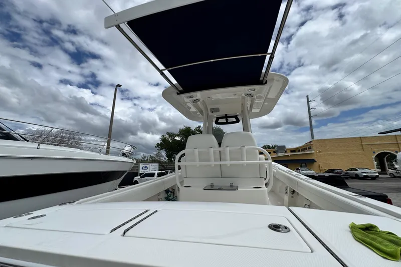 Slide: The Image of 2022 Regulator 28 boat with T-top, docked under cloudy sky. - 62