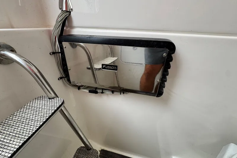 Slide: The Image of 2022 Regulator 28 boat interior with Fusion audio panel and metal steps. - 67