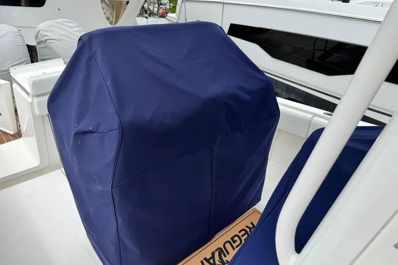 Slide: The Image of 2022 Regulator 28 boat with blue protective cover on deck. - 71