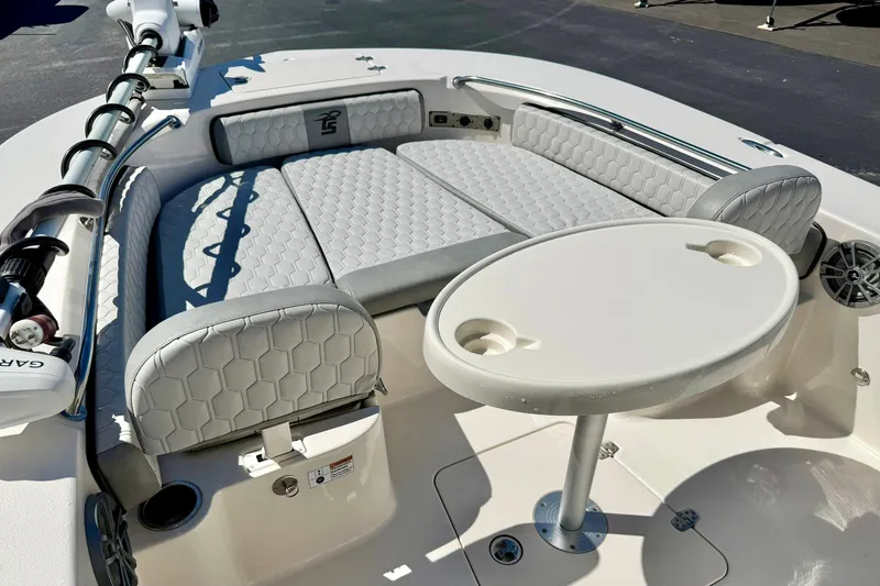 Slide: The Image of 2024 Carolina Skiff 26 Ultra Elite boat interior with cushioned seating and round table. - 11