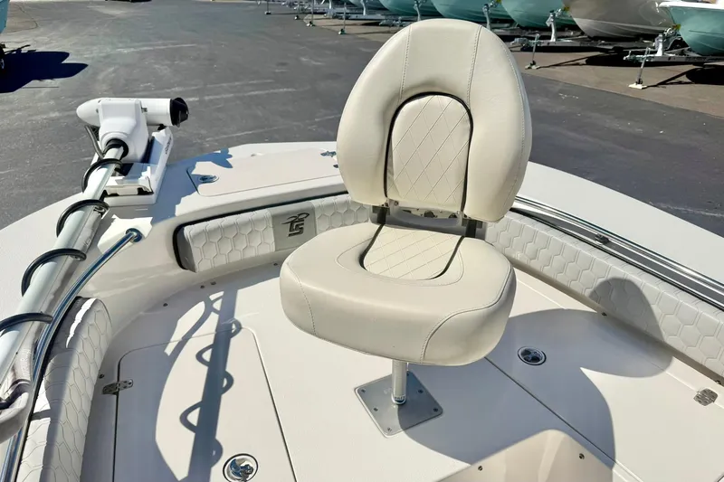 Slide: The Image of 2024 Carolina Skiff 26 Ultra Elite boat with cushioned seating and trolling motor. - 12