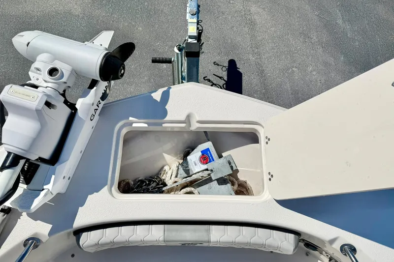 Slide: The Image of 2024 Carolina Skiff 26 Ultra Elite boat storage compartment with anchor and equipment. - 15