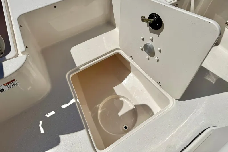 Slide: The Image of 2024 Carolina Skiff 26 Ultra Elite boat storage compartment with open hatch. - 18