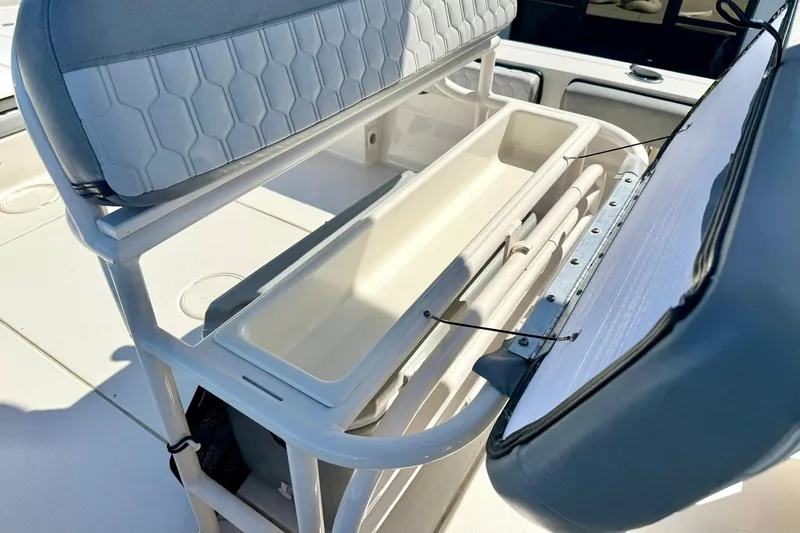 Slide: The Image of 2024 Carolina Skiff 26 Ultra Elite boat seat with storage compartment open. - 23