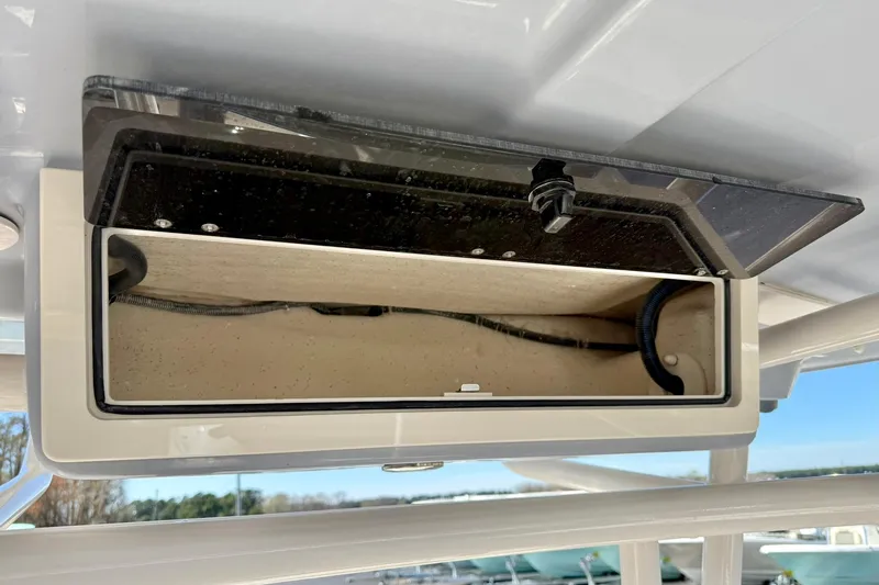 Slide: The Image of Open storage compartment on 2024 Carolina Skiff 26 Ultra Elite boat. - 27