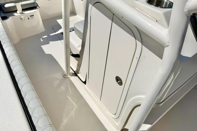 Slide: The Image of 2024 Carolina Skiff 26 Ultra Elite boat interior with storage compartment and seating. - 28