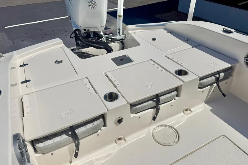Slide: The Image of 2024 Carolina Skiff 26 Ultra Elite boat deck with storage compartments and motor. - 31