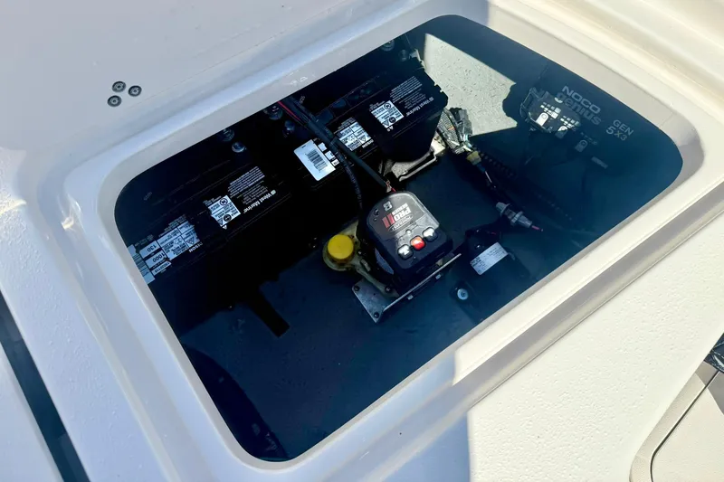 Slide: The Image of Battery compartment of 2024 Carolina Skiff 26 Ultra Elite boat, featuring electrical components. - 34
