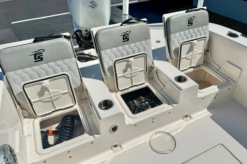 Slide: The Image of 2024 Carolina Skiff 26 Ultra Elite boat seats with storage compartments and cup holders. - 36
