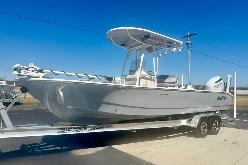 Slide: The Image of 2024 Carolina Skiff 26 Ultra Elite boat on trailer, clear blue sky background. - 5