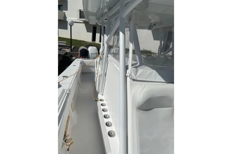 Slide: The Image of 2009 SeaHunter 40 Center Console boat with sleek white interior and rod holders. - 11