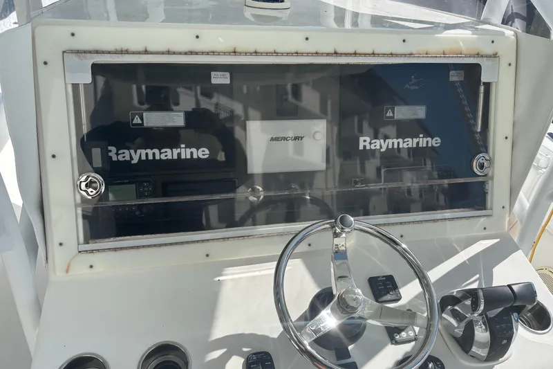 Slide: The Image of Control panel of 2009 SeaHunter 40 Center Console with Raymarine and Mercury equipment. - 12