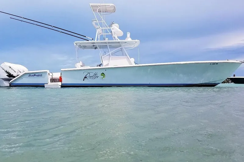 Slide: The Image of 2009 SeaHunter 40 Center Console boat on calm water, side view. - 3