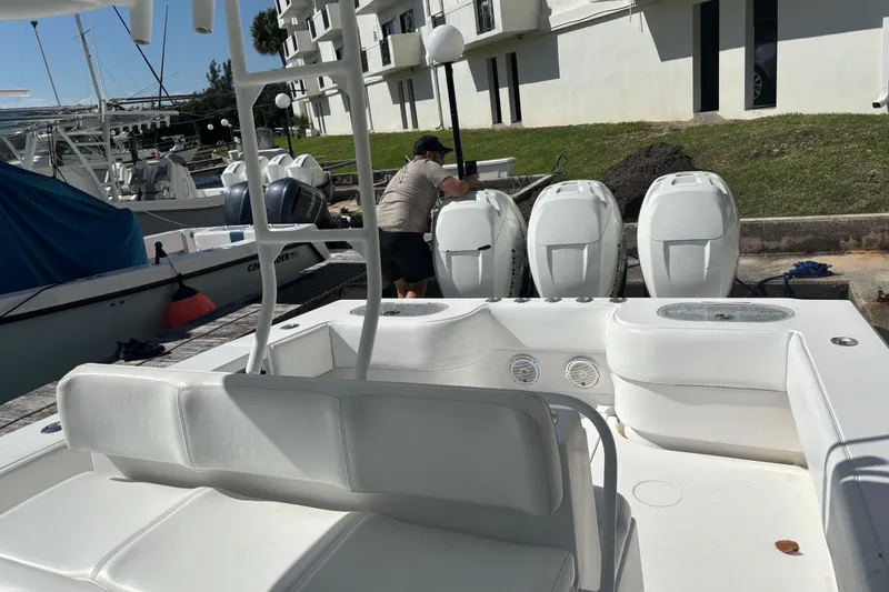 Slide: The Image of 2009 SeaHunter 40 Center Console boat docked with triple outboard engines. - 6