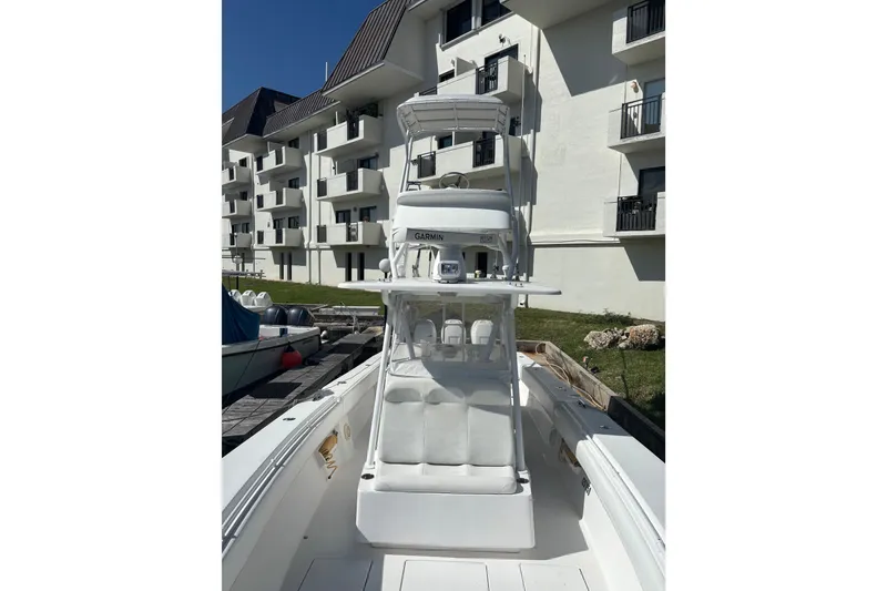 Slide: The Image of 2009 SeaHunter 40 Center Console boat docked near a residential building. - 7