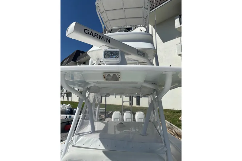 Slide: The Image of 2009 SeaHunter 40 Center Console boat with Garmin radar, white exterior, and spacious seating. - 9