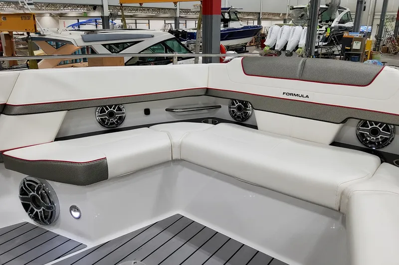 Slide: The Image of Interior of 2026 Formula 400 Super Sport Crossover boat with luxurious seating and speakers. - 13