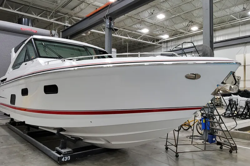 Slide: The Image of 2026 Formula 400 Super Sport Crossover boat in a showroom, showcasing sleek design and modern features. - 2