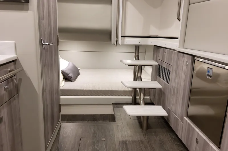 Slide: The Image of Interior of 2026 Formula 400 Super Sport Crossover, featuring modern cabin with bed and steps. - 27