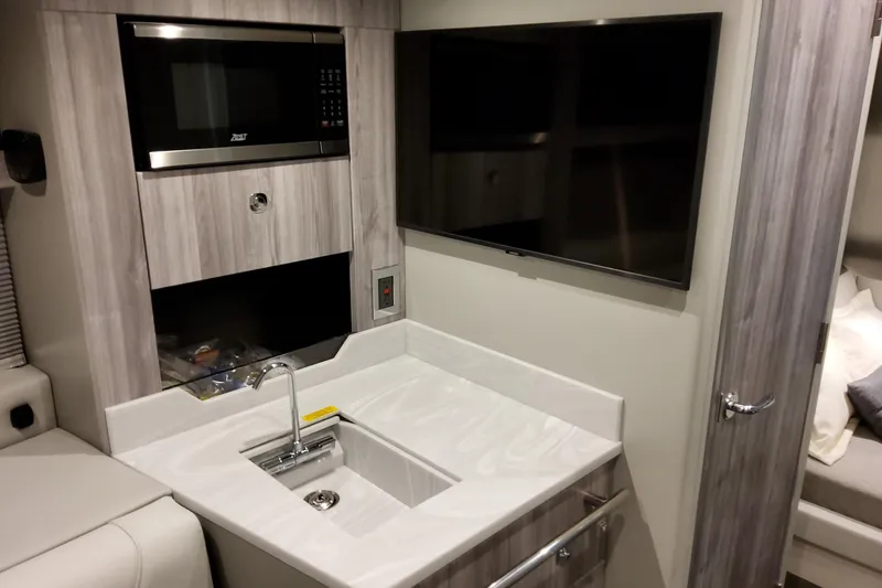 Slide: The Image of Interior of 2026 Formula 400 Super Sport Crossover with modern kitchenette and TV. - 33