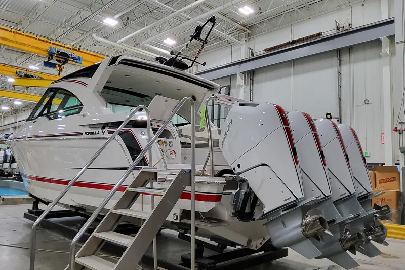 Slide: The Image of 2026 Formula 400 Super Sport Crossover boat with quad Mercury engines in a factory setting. - 5