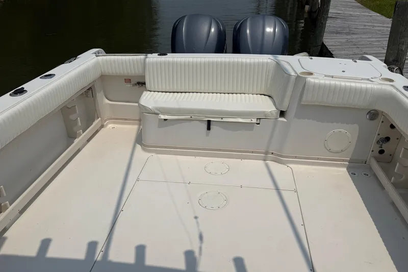 Slide: The Image of 1999 Grady-White Marlin 300 boat interior with seating and twin engines. - 12